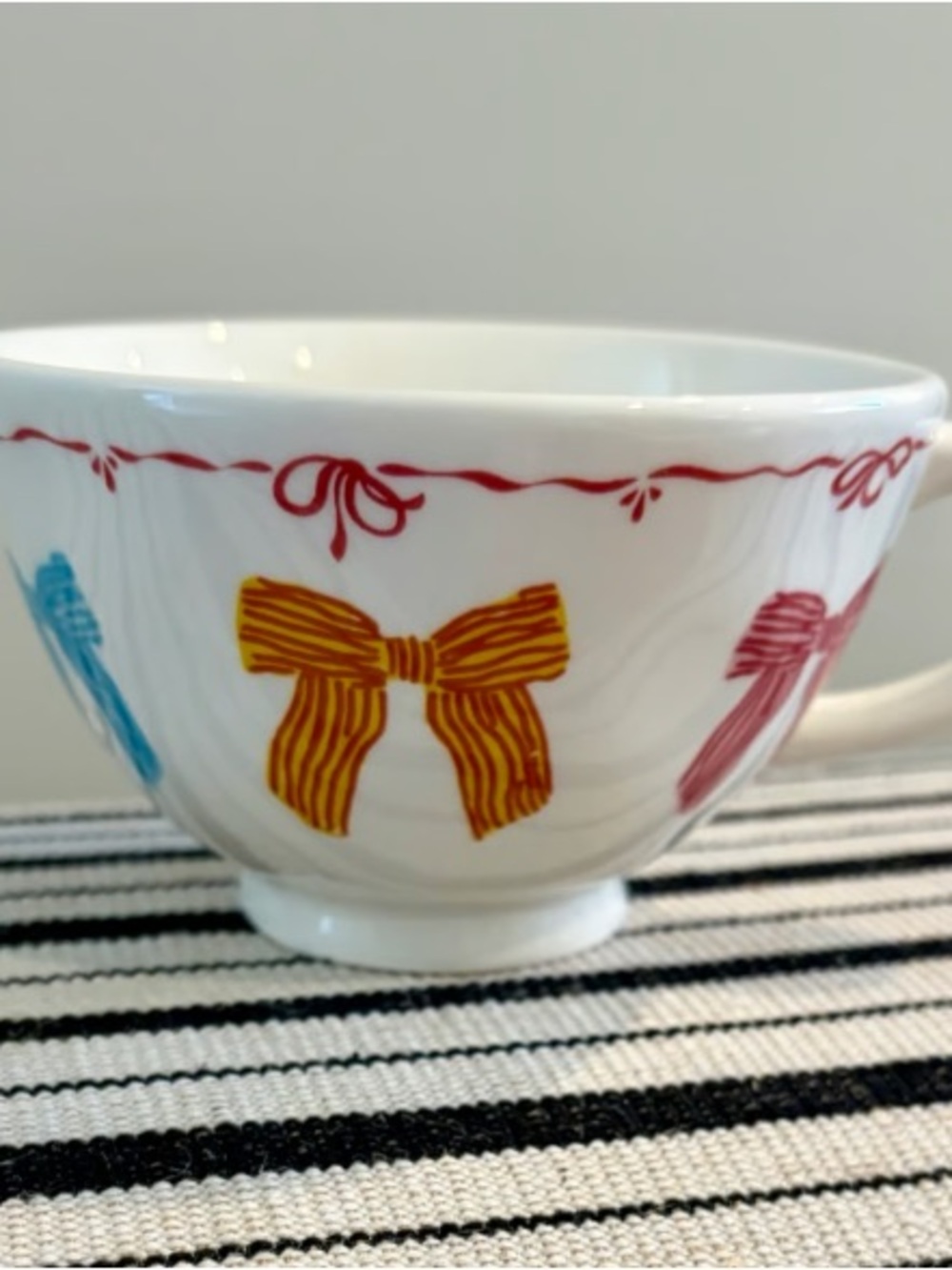 White Ceramic Bowl with Yellow Bow Accent and Multicolor Bow Trim